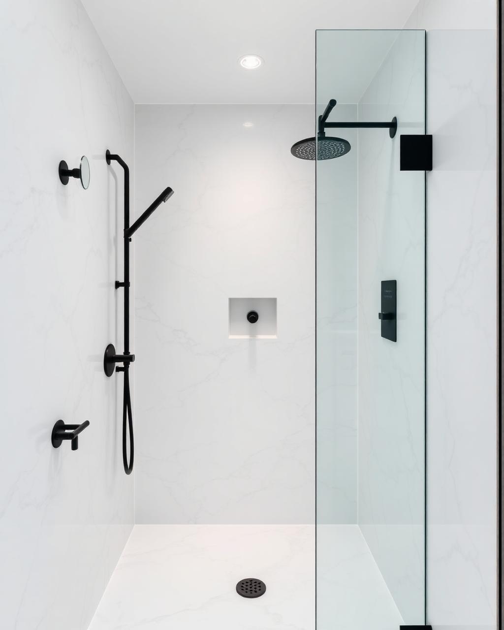 Modern walk-in shower with marble-pattern acrylic walls and matte black hardware